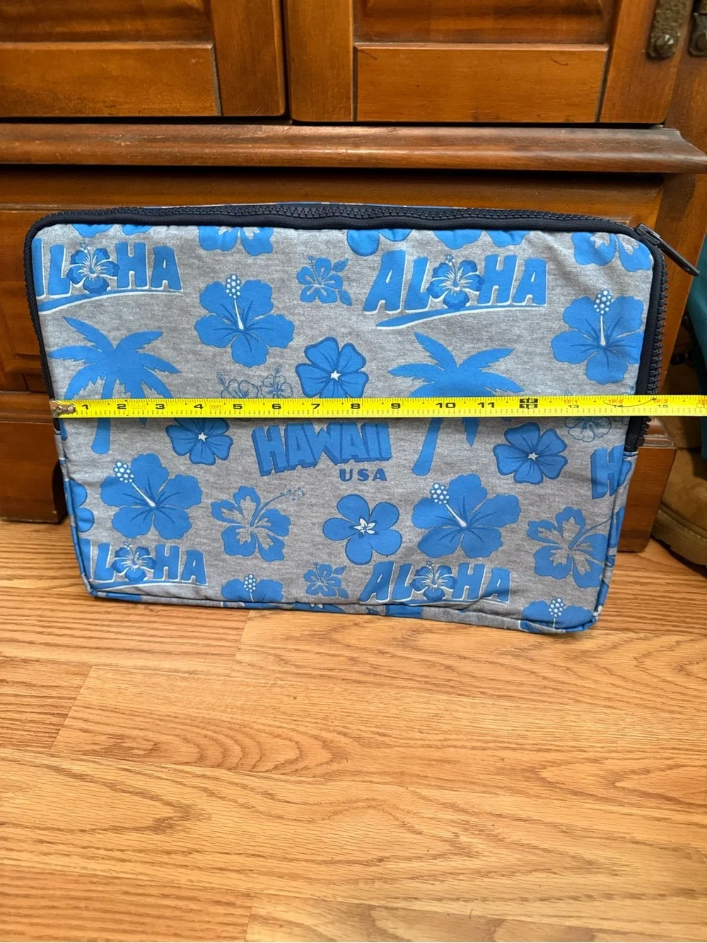 LeSportsac brand travel pouch or laptop case featuring a blue and grey hibiscus